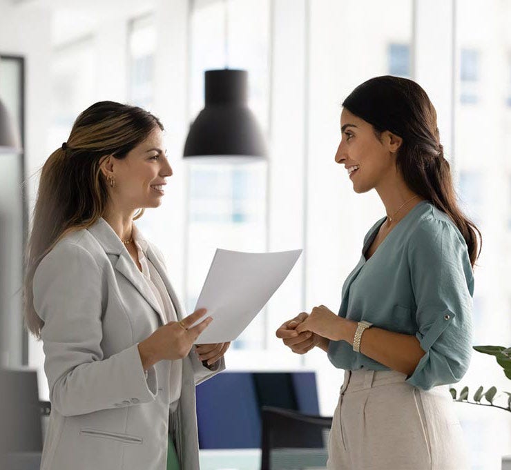 Two women talking in office Two women talking in office