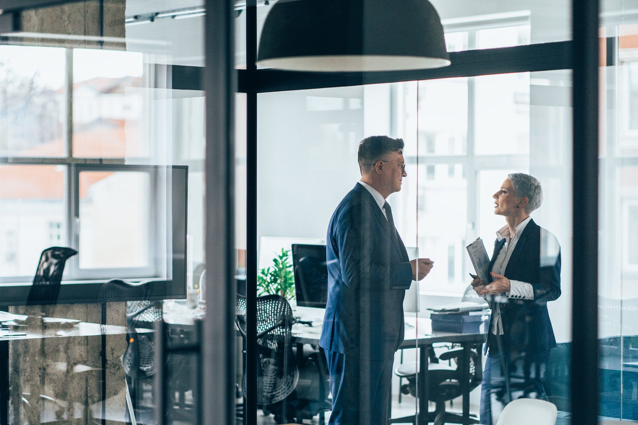 two people discussing in meeting room