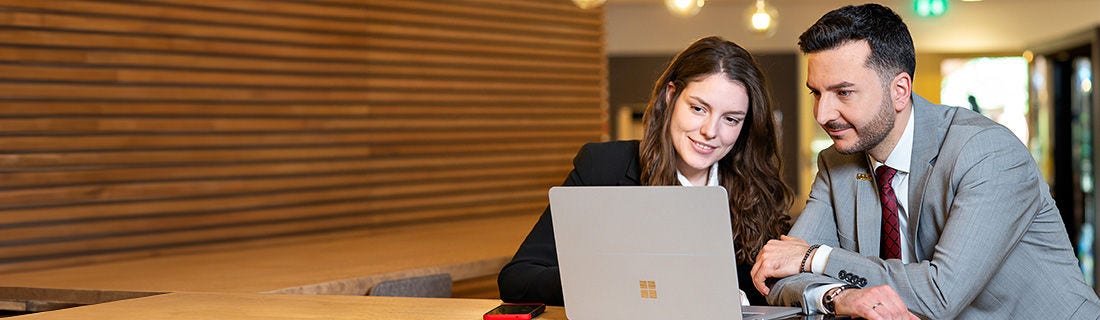 Man and a women looking at a laptop together
