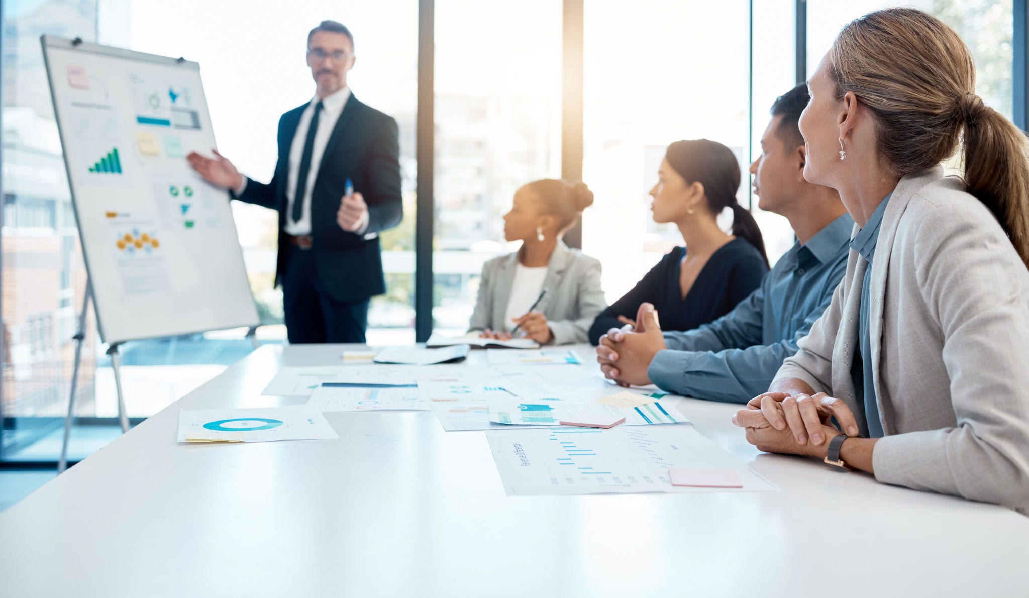 Chart, ceo and business people in a meeting presentation planning, talking or speaking on sales growth and our vision. Mentor, leadership and marketing manager coaching a global team or office group.