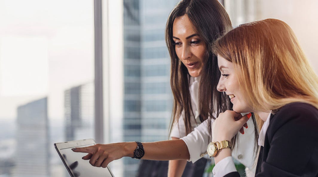 two women looking at laptop