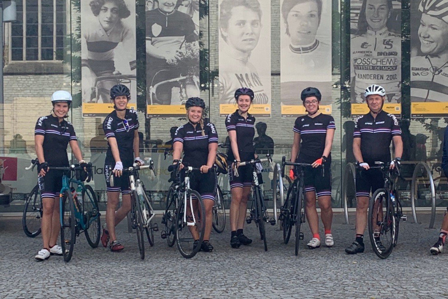 A group of people posing with their bicycles.