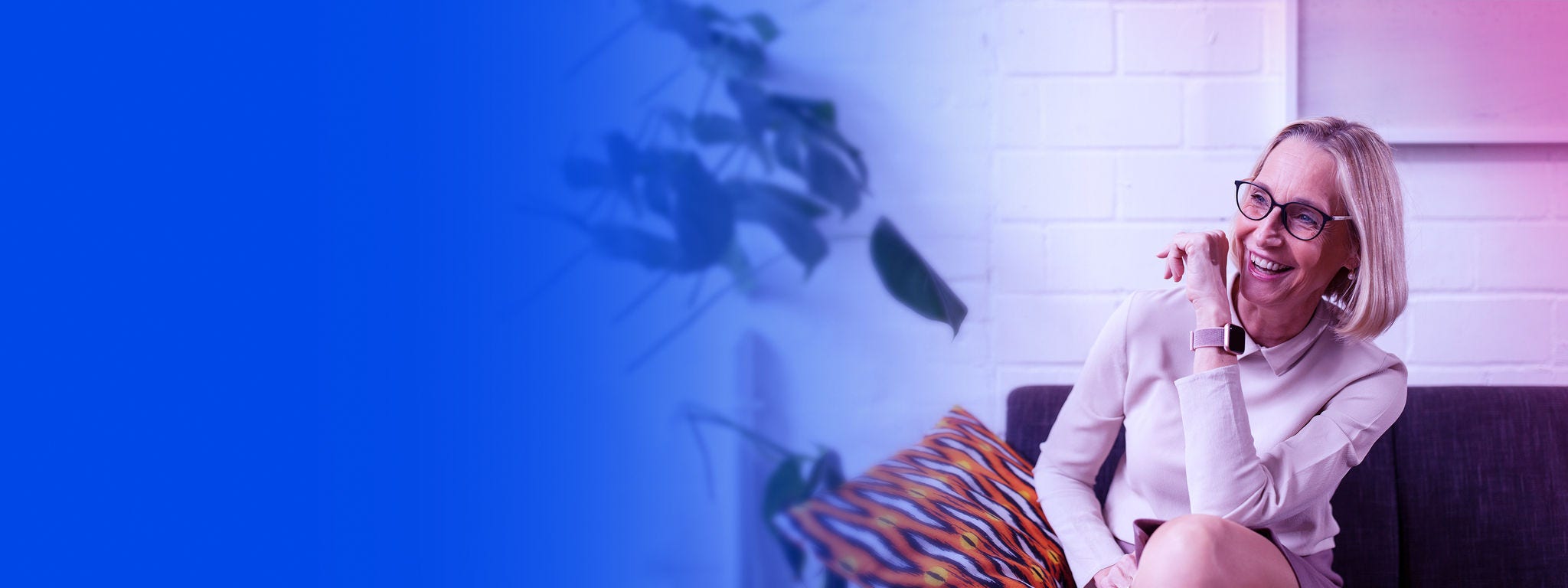 Mature businesswoman sitting on couch in office lounge