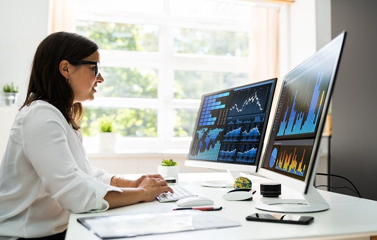 Analyst Women Looking At KPI Data On Computer Screen