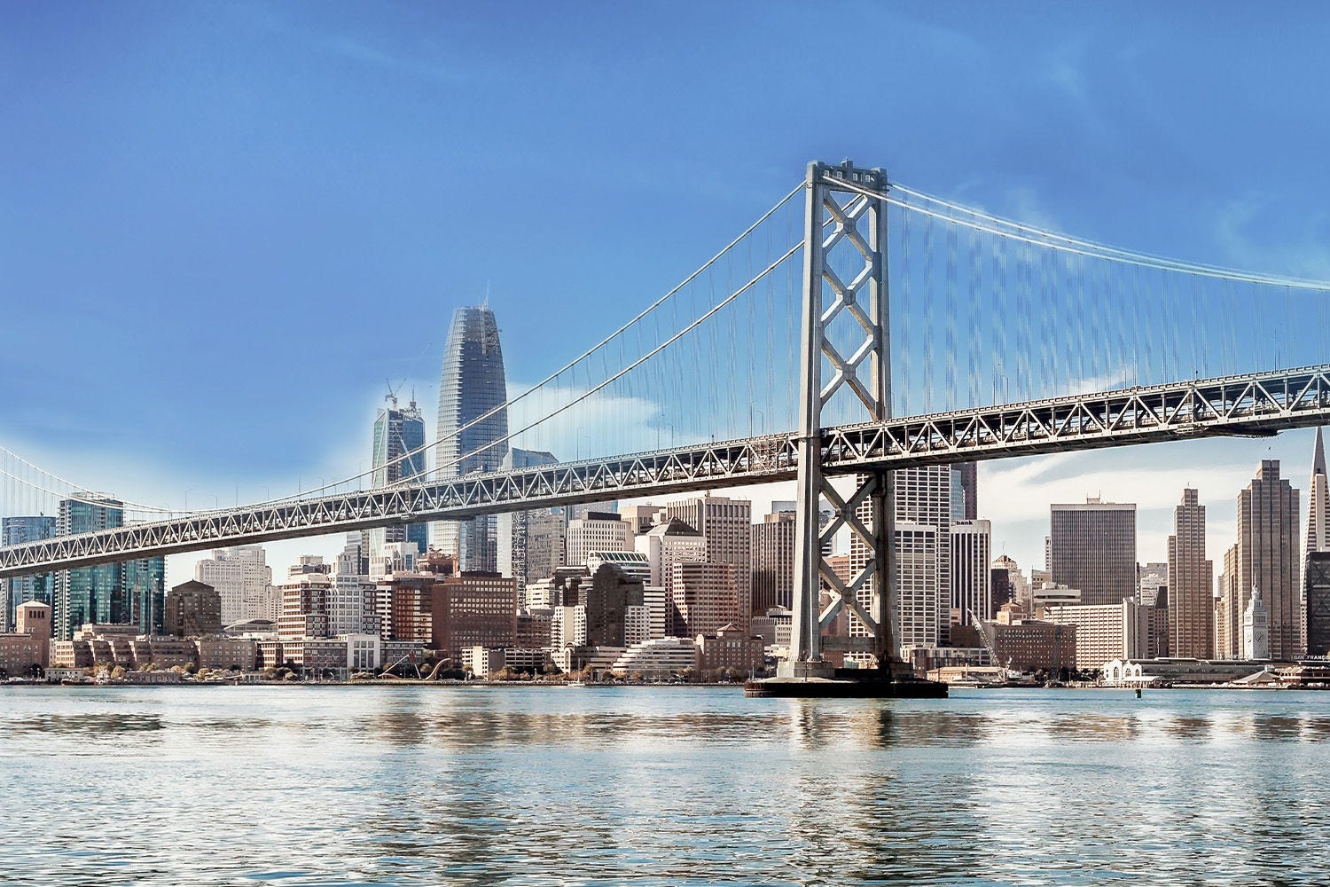 Bridge over waters against city line