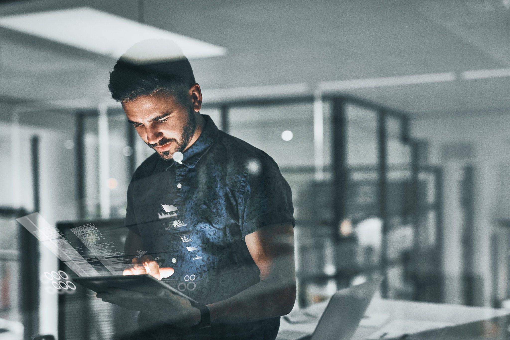 man looking into laptop standing