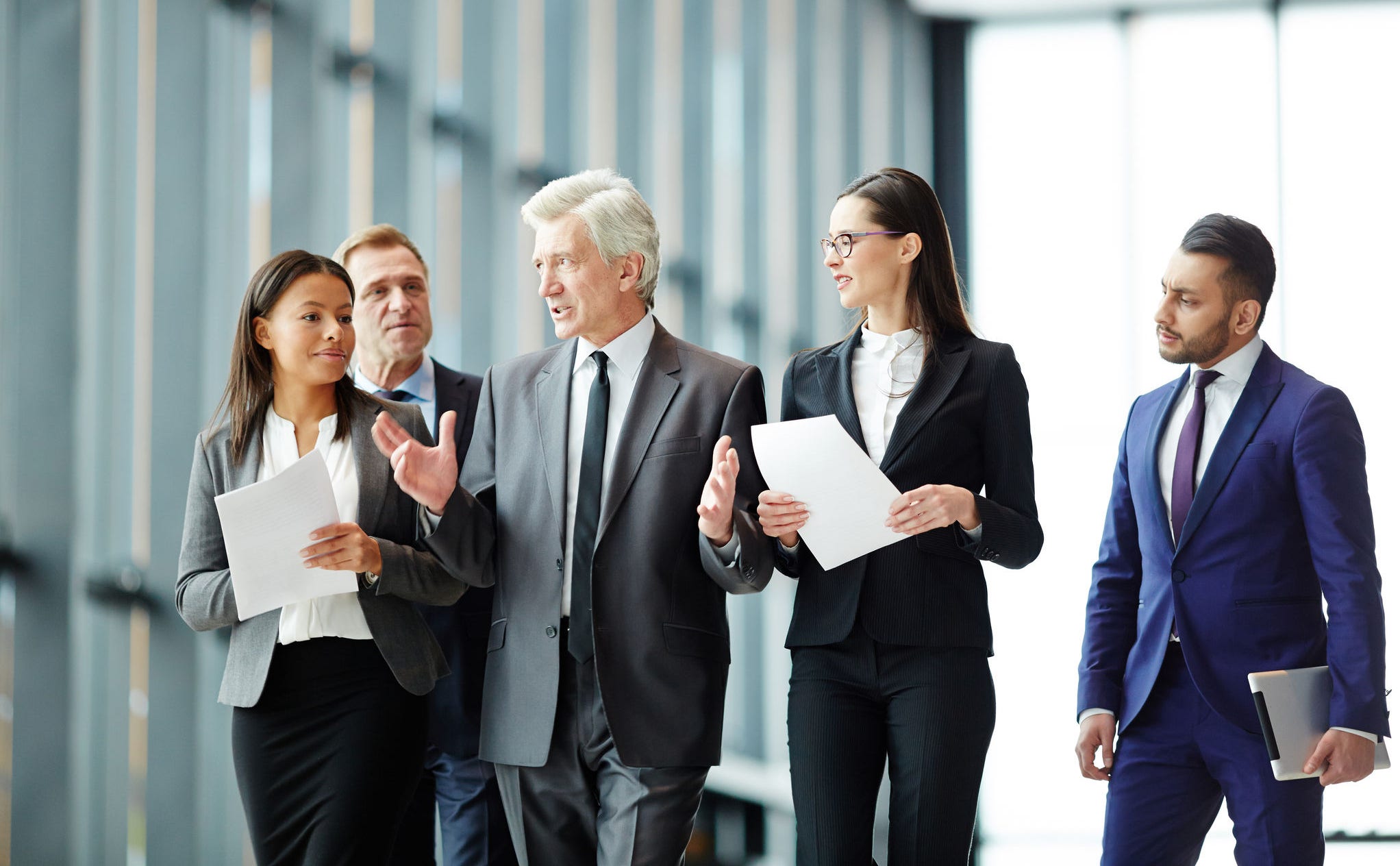 Business leader preparing his team for conference on their way to congress hall