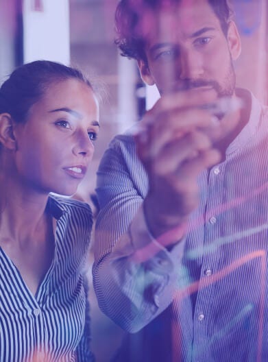 Programmers exchanging ideas written on a transparent board