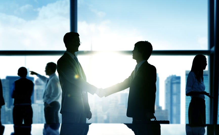 Business men shaking hands to confirm deal