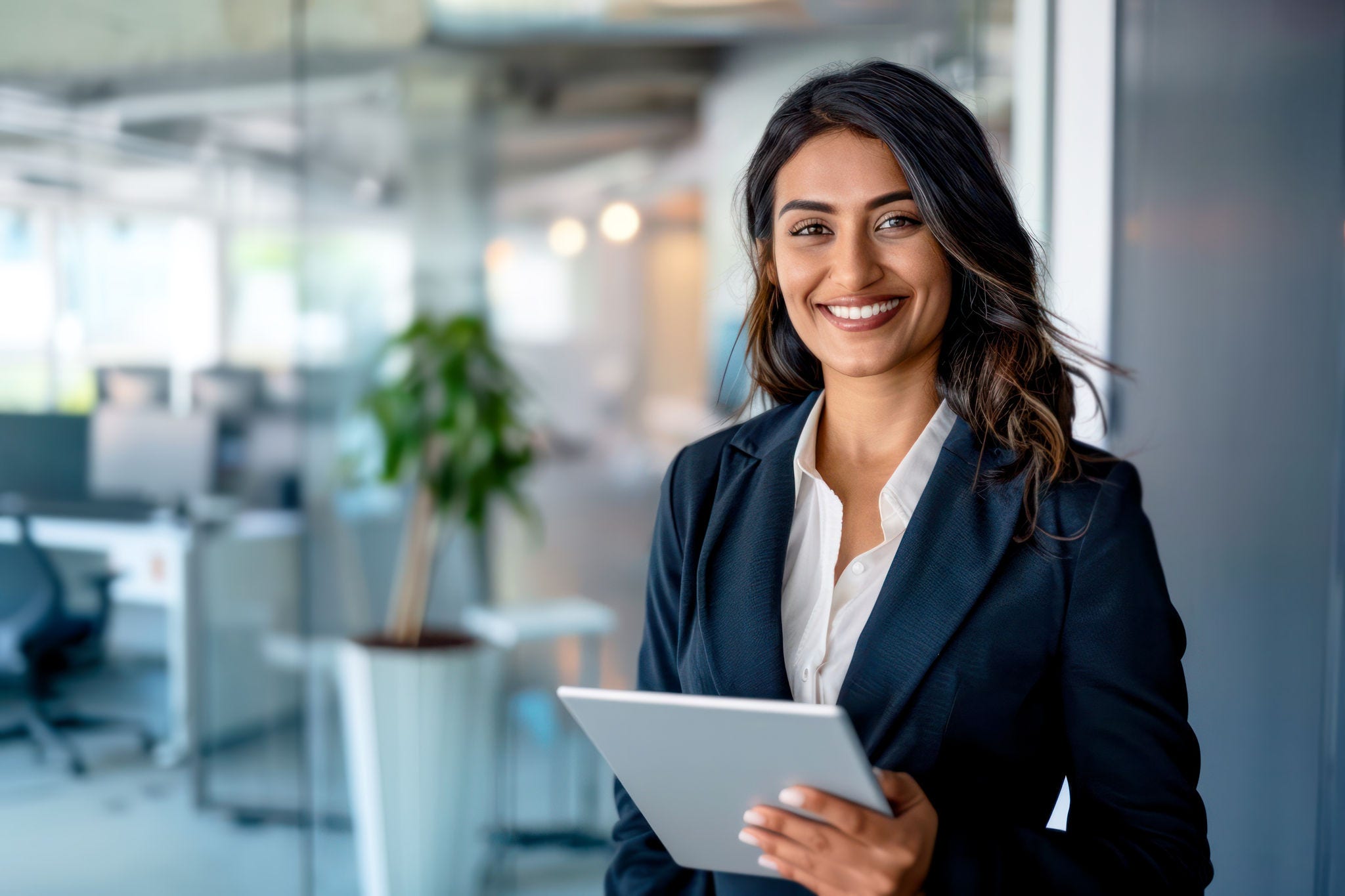 Confident Mixed-Race Businesswoman Holding Digital Tablet in Modern Office