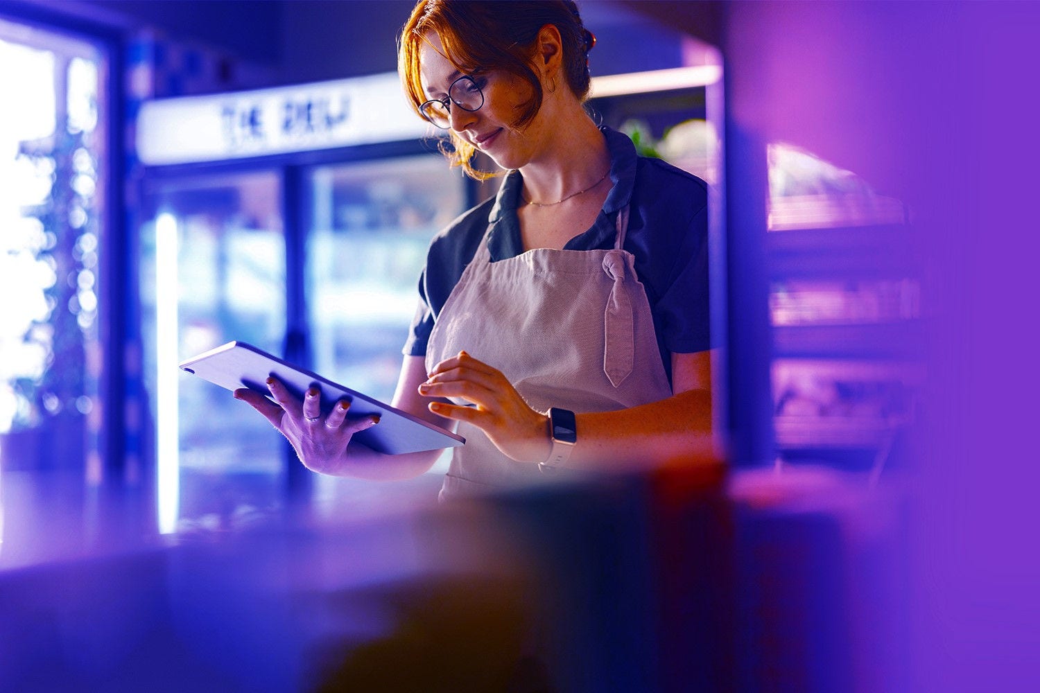 Grocer checking on tablet computer