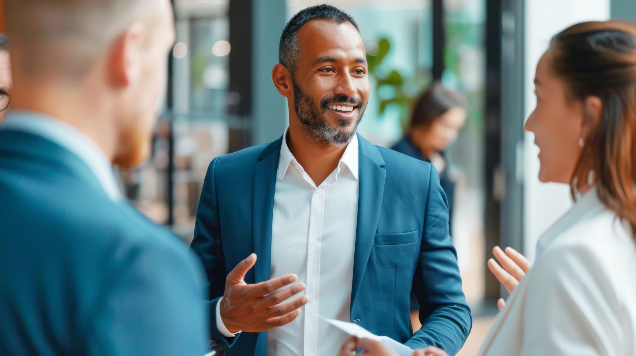 Business meeting in a contemporary office setting, featuring a multiethnic group of colleagues discussing ideas --ar 16:9 --style raw Job ID: a2fc57e8-3b44-40f0-90cd-651aa330bbf2