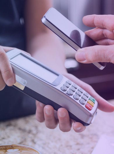 Person making an ATM payment with their mobile phone