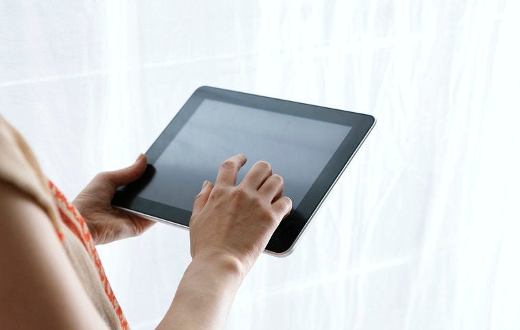 Female using digital tablet