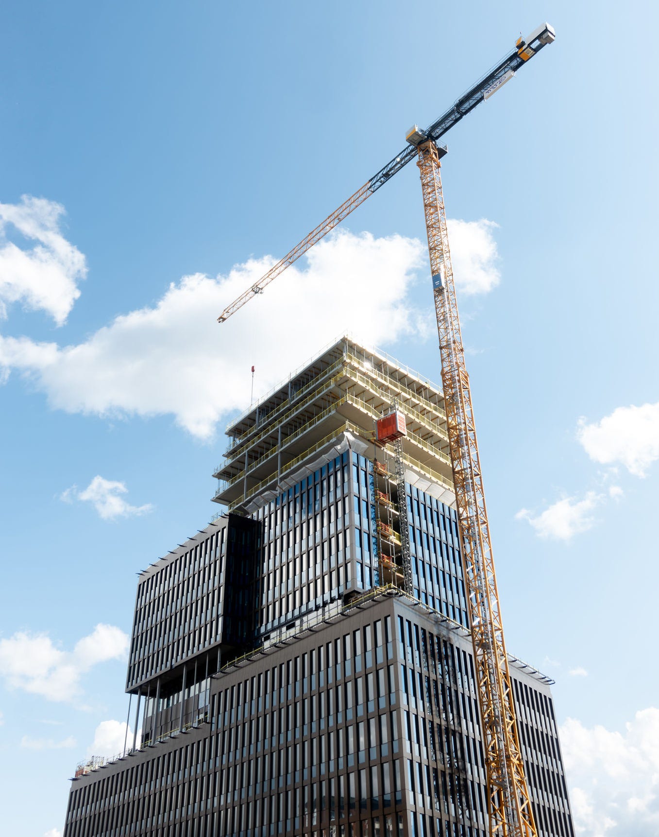 2165813155 construction site of modern glass facade skyscraper