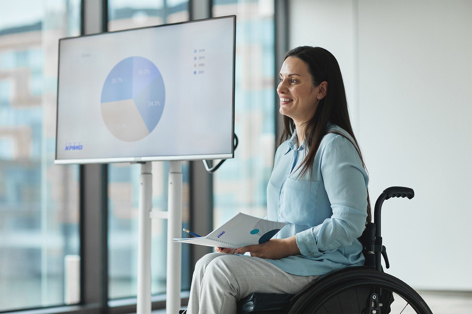 Working woman in wheelchair presenting