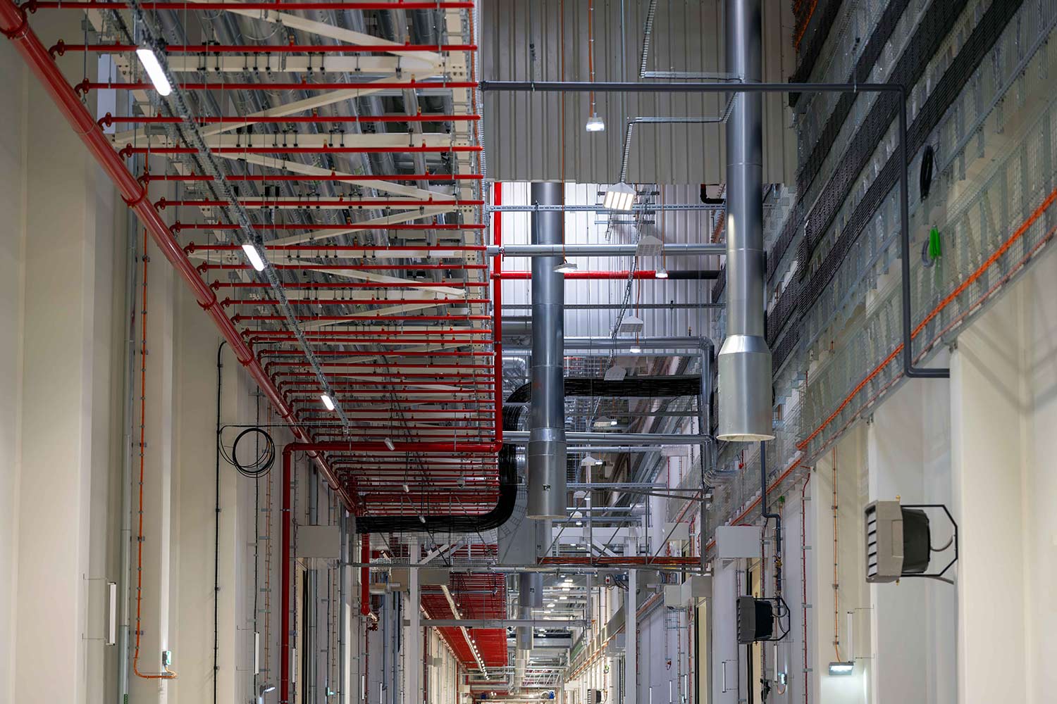 Piping and wiring in corridor representing MEP cost management