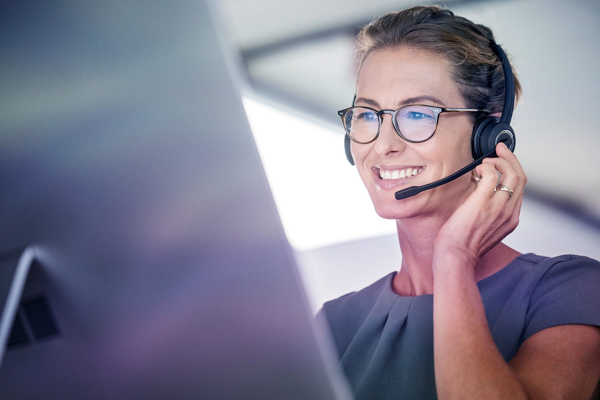 Customer service, woman and happy call center agent giving advice online using a headset. Operator, telemarketing and support with hotline consultant working for contact us help or arm consulting