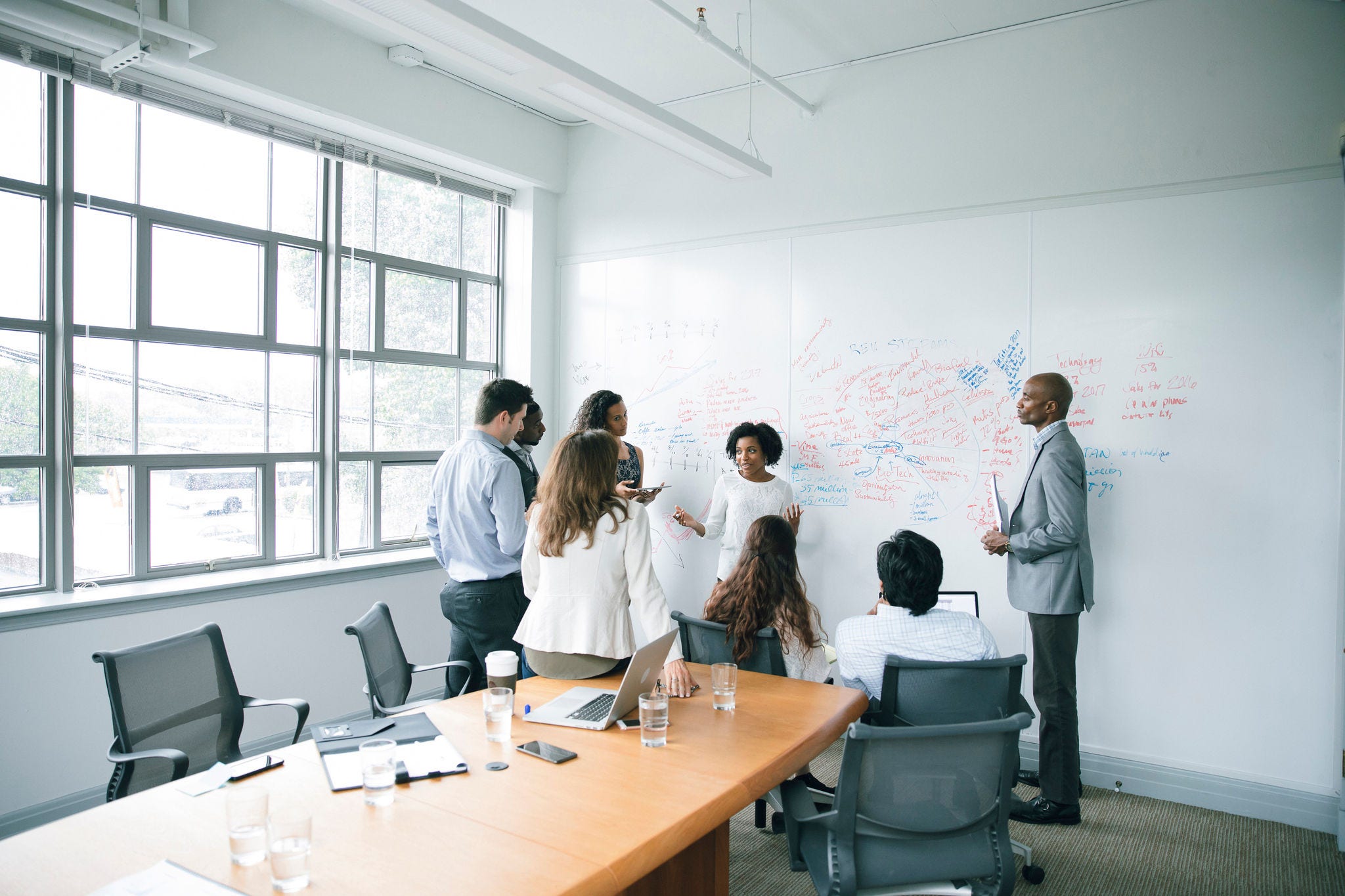 Colleagues in meeting room woman with glasses in digital space banner