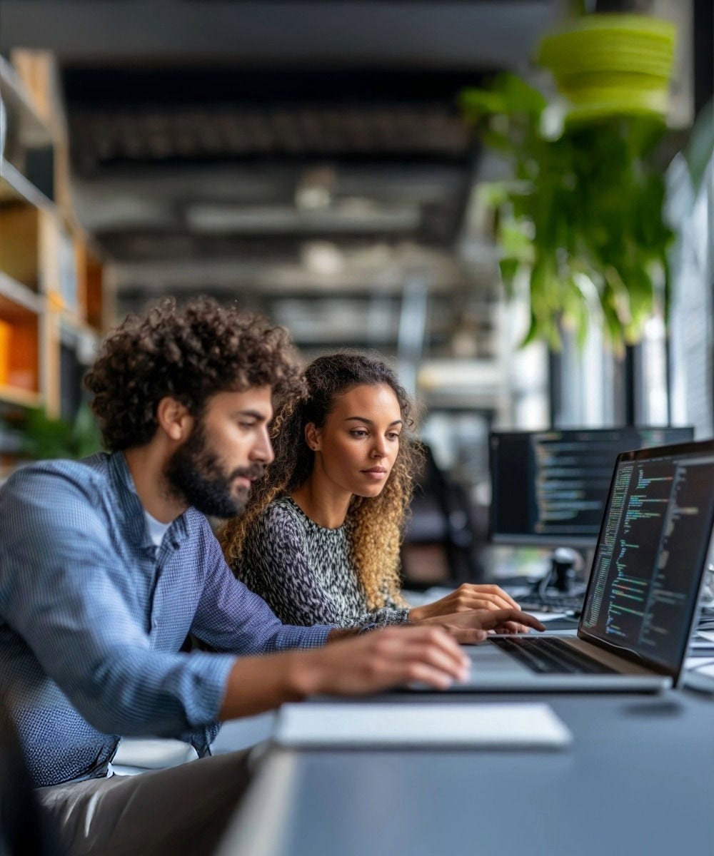 Two people looking at a tablet in an office space