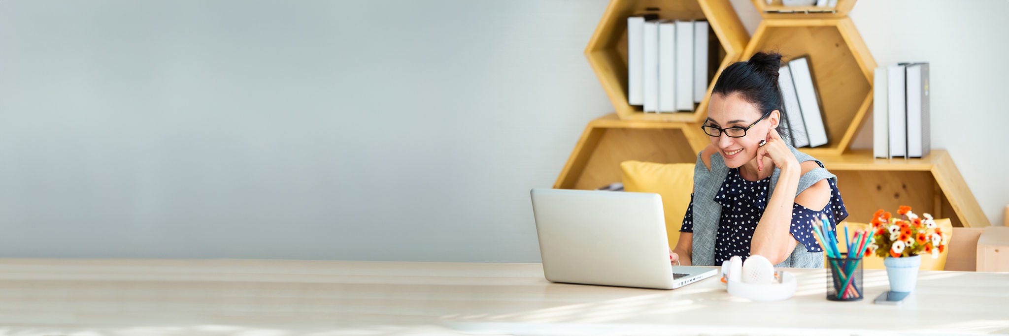 Happy excited successful Beautiful businesswoman triumphing in modern office with laptop, success happy pose