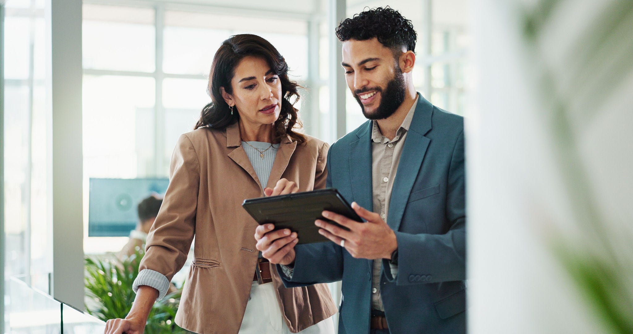 woman and man holding tablet