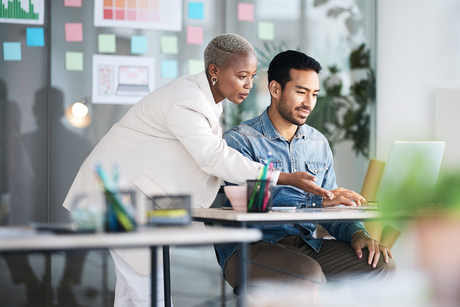 Office laptop, diversity and business people reading online report, website design feedback or research project. Collaboration, staff mentor and team designer working on company homepage development.