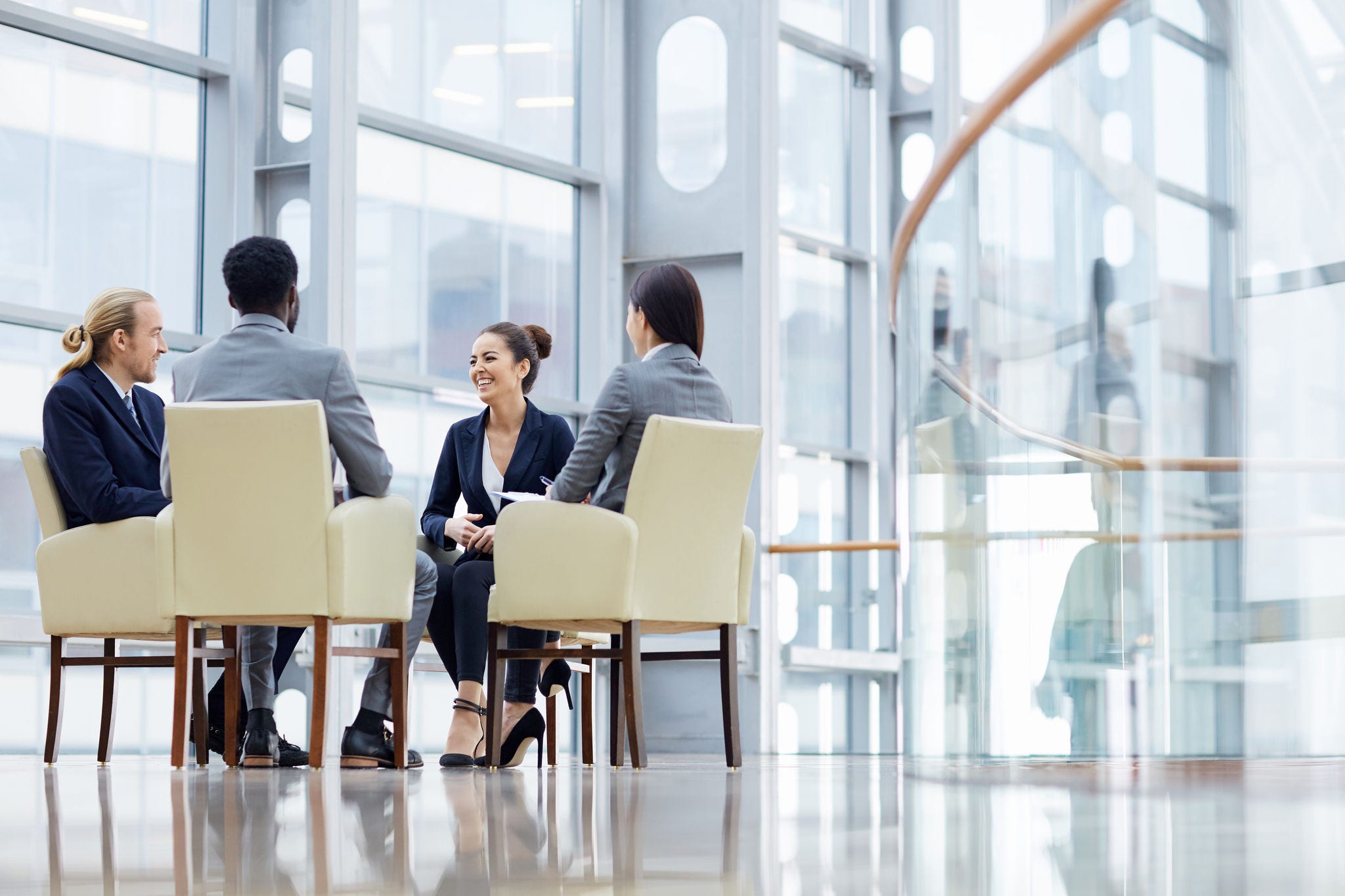 two-women-and-a-man-laughing-and-discussing-while-sitting