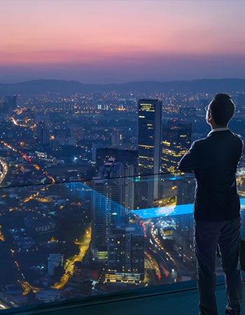 man looking at city light