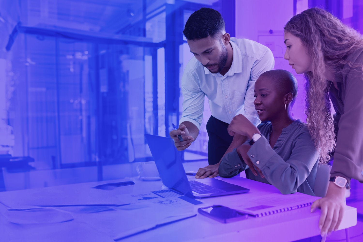 People looking at a computer screen in an office