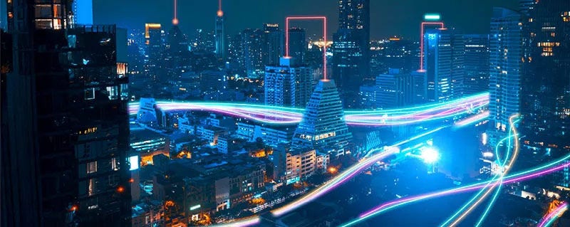 Cityscape at night with neon light trails