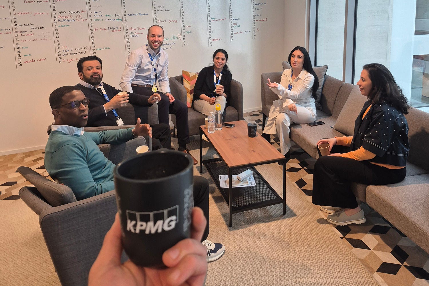 A group of people working together in the coffee corner.