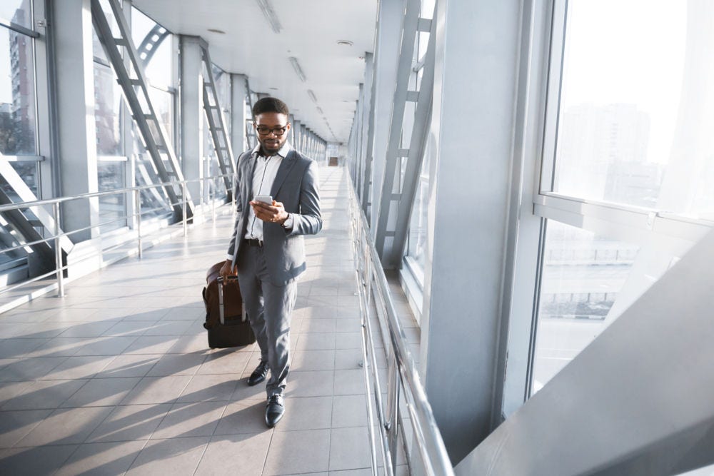 Man pulling a suitcase on airport