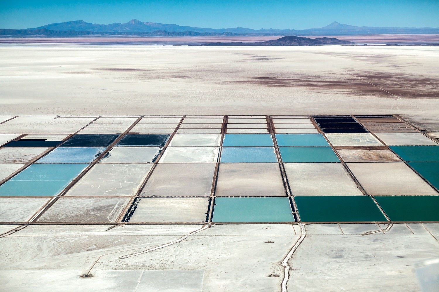 Salt lake and blue pools in desert