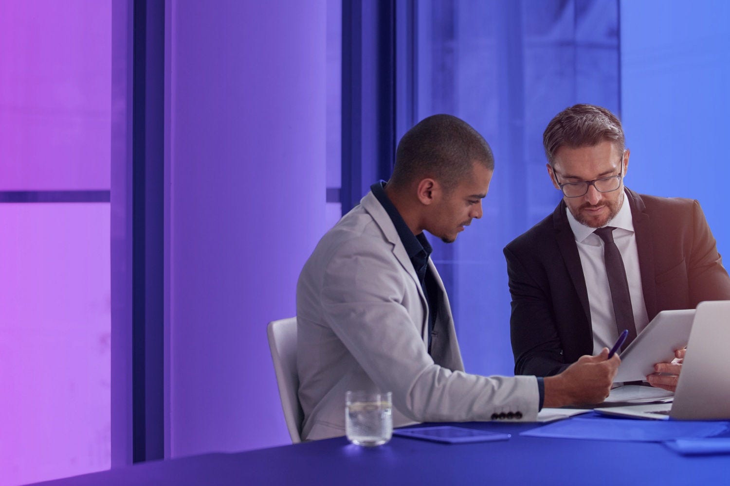 Two businessmen discussing at table