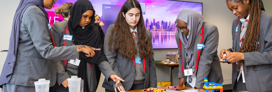 School children interacting with games on a table