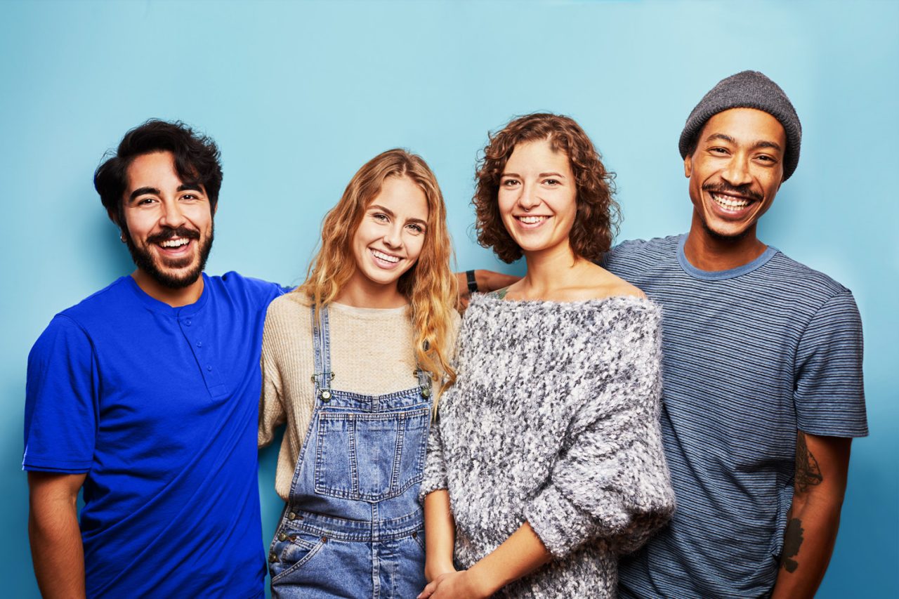 Grads careers pathways Tax & Legal Four people standing with blue background