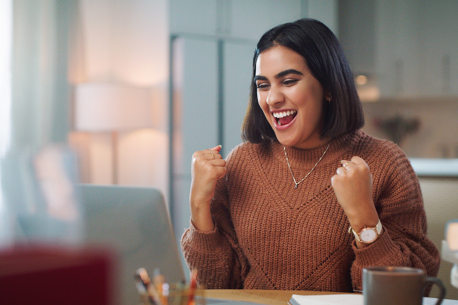 students at a table with laptops and books