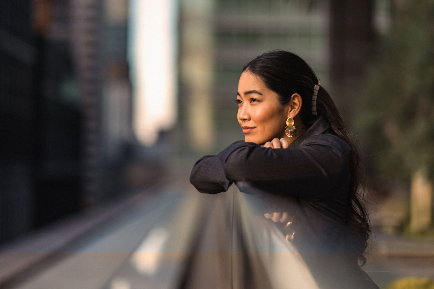 smiling woman leaning against a rail