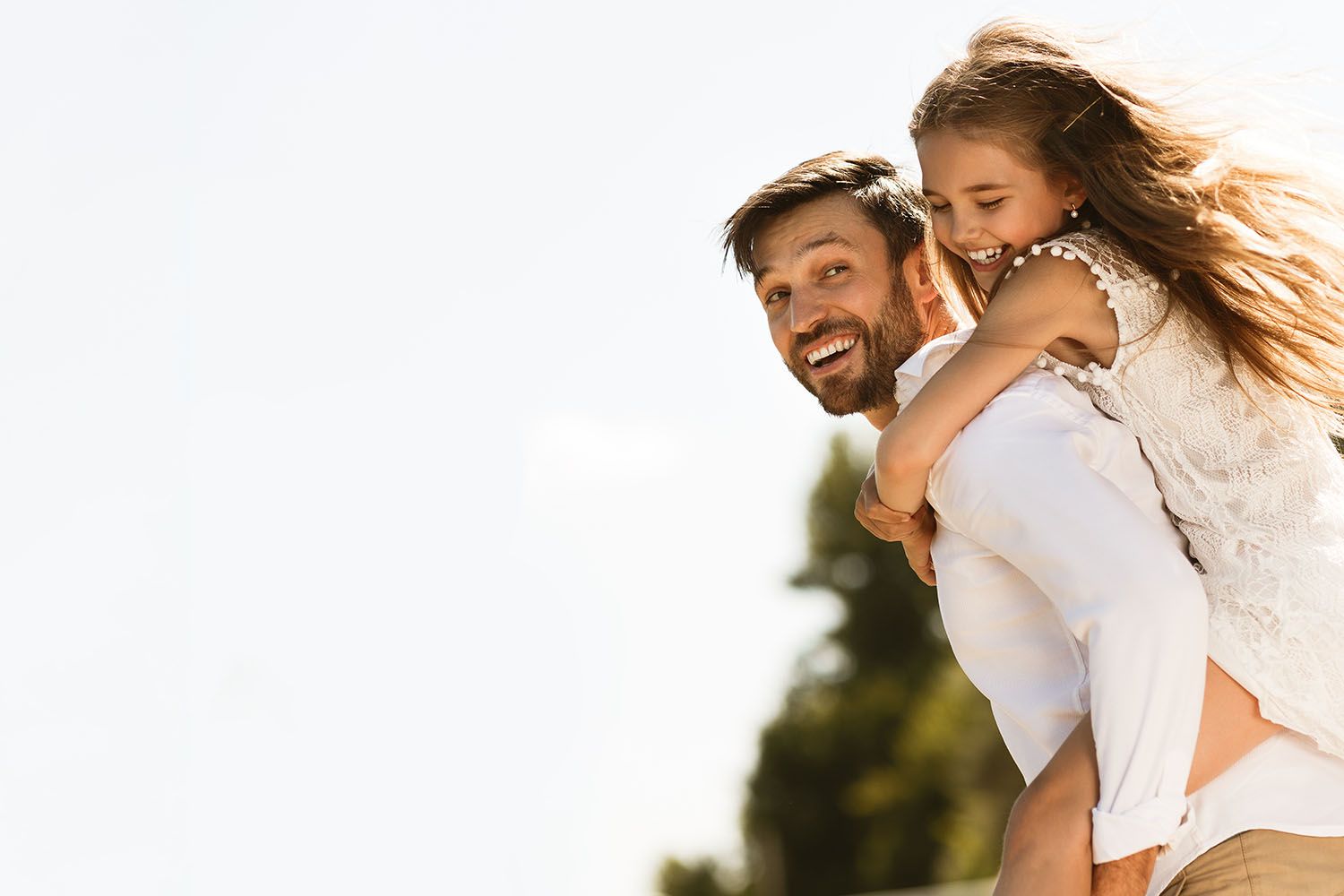 Father carrying daughter on back