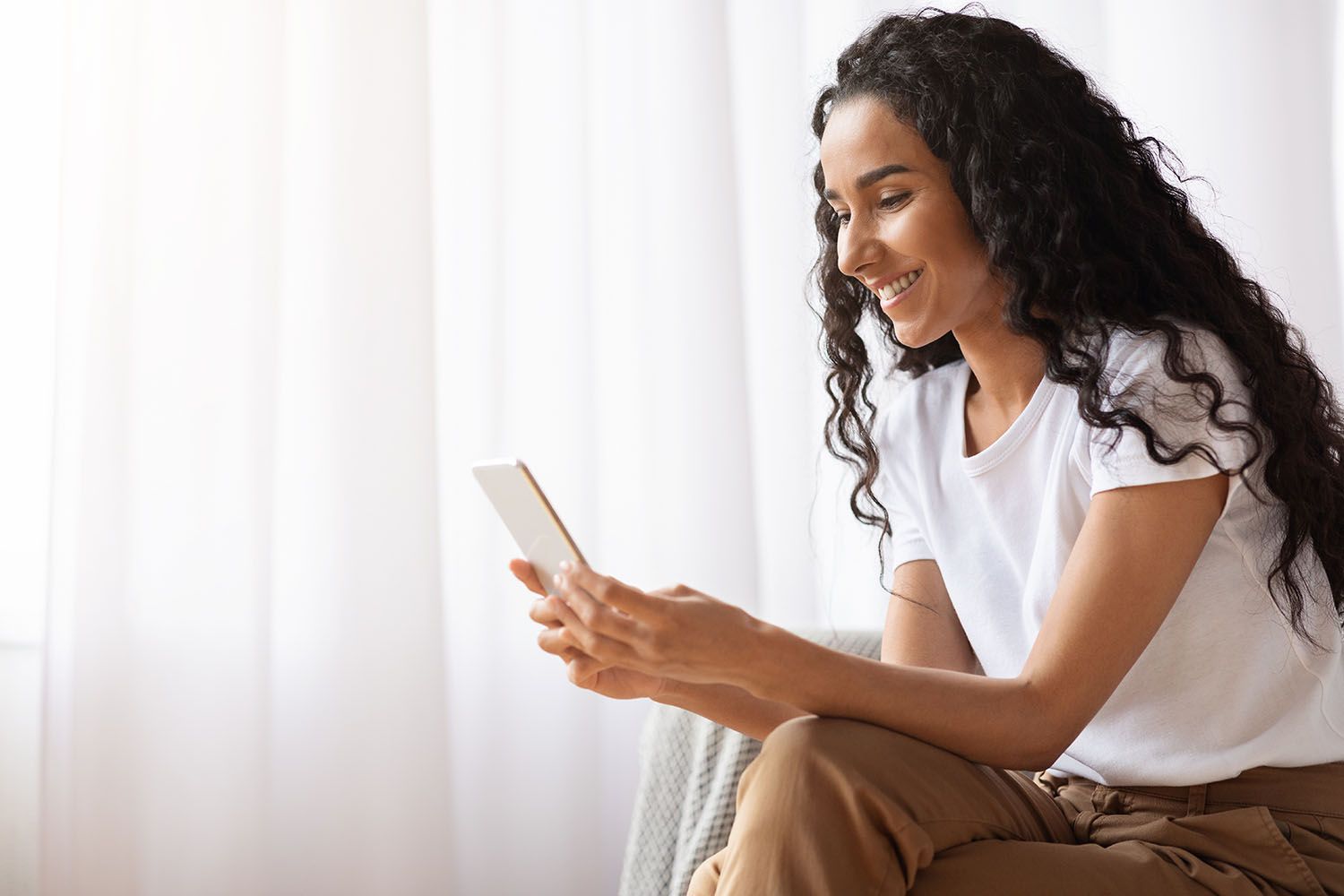 Woman smiling while on phone